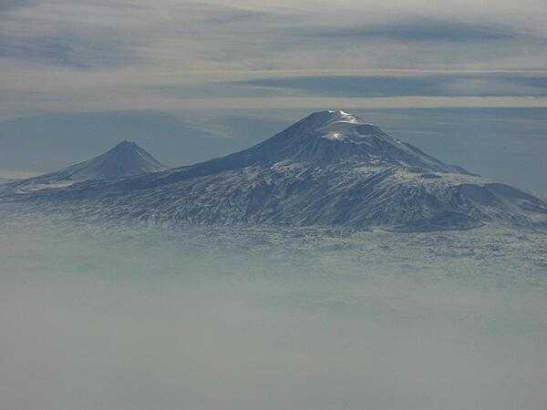 A view of Mount Ararat in western Turkey through the fog. The highest of its two peaks, Greater Ararat, is the tallest mountain in Turkey at 5,166 m (16,949 ft). Although located some 32 km (20 mi) from the Armenian border, the dormant volcano dominates the skyline of Yerevan, Armenia's capital. This photo was snapped after take-off from the Yerevan airport.