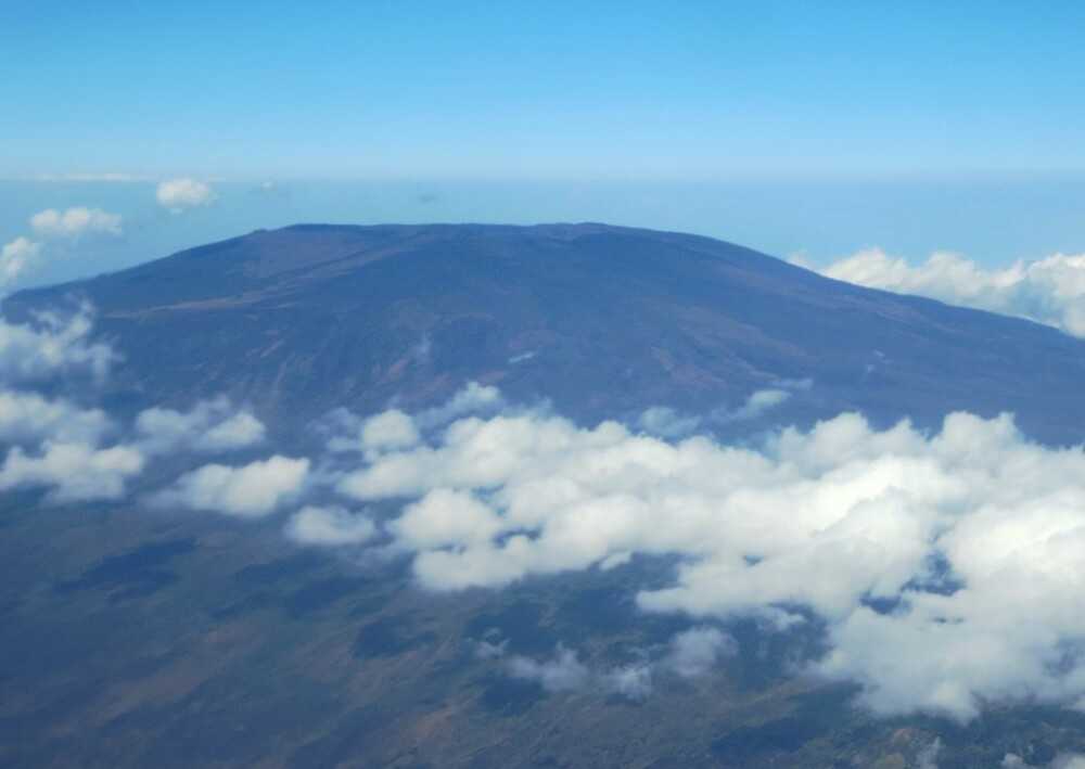 The active volcano Mount Karthala is the highest point in Comoros, at 2,361 m (7,746 ft), and it is the larger of the two shield volcanoes forming Grande Comore Island, the archipelago’s main island. Shield volcanoes are the largest volcanoes on earth and are named for their resemblance to a warrior’s shield lying on the ground. Mount Karthala’s name is derived from the Arabic word for “warrior’s shield.”