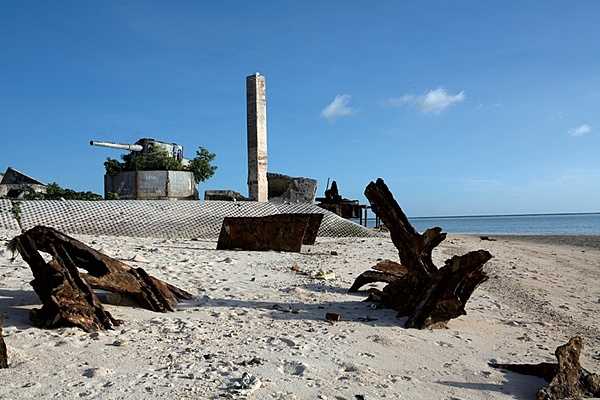 The remains of a World-War-II-era Japanese 8-inch gun mount sit on the point at Green Beach, Betio Island, Kiribati. Photo courtesy of the US Marine Corps/ Cpl. Aaron Hostutler.